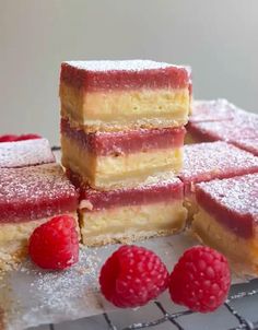 raspberry shortbreads stacked on top of each other with fresh raspberries