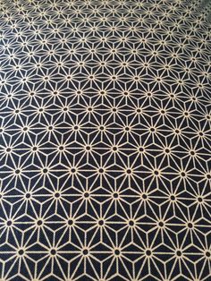 a black and white table cloth with an intricate design on it's surface, in the shape of a flower of life