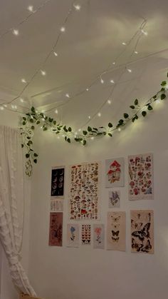 a bedroom with white walls and lots of pictures on the wall