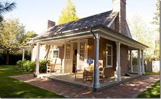 a small brick house with a porch and covered patio