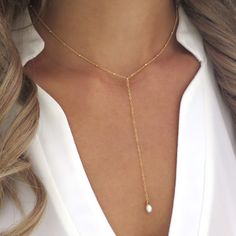 "This dainty y lariat necklace features a focal piece of a beautiful freshwater pearl hung on a 14k gold filled chain. The perfect piece of date night jewelry, this gold Y necklace is perfect for a plunging v neck! Shop Landon Lacey Jewelry: www.etsy.com/shop/landonlacey it's in the DETAILS . . . » 14k gold filled chain » Spring ring clasp » Freshwater pearl » The model is wearing this necklace at 15\" (doesn't include the drop), but she is petite and 15\" may sit shorter or longer depending on