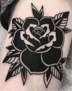 a black and white rose tattoo on the arm