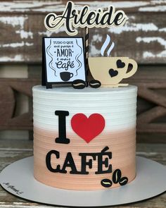 a cake that has been decorated to look like a coffee cup and i love cafe