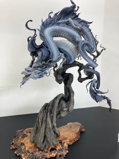 a sculpture of a dragon on top of a tree stump