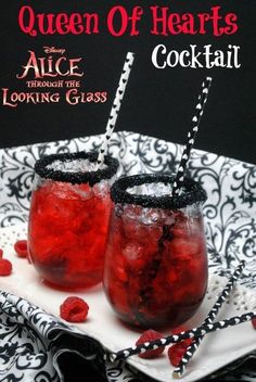 two glasses filled with liquid sitting on top of a white and black plate next to each other