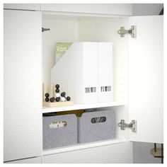 a white cabinet with two bins and some sort of storage