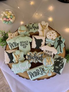 decorated cookies are arranged on a platter for a baby's first birthday party