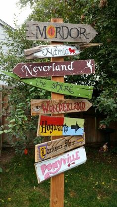 a wooden sign that has many different signs on it