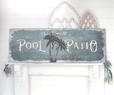 a sign that says pool and patio hanging on the wall next to a fire place