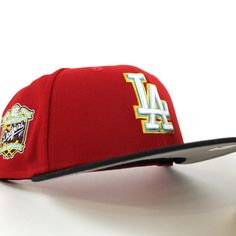 a los angeles angels cap with embroidered logos on the front and side panels, sitting on a white surface