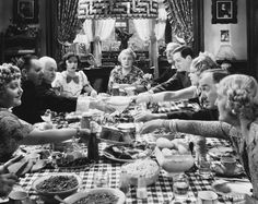 a group of people sitting around a table eating food