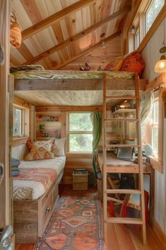 there is a loft bed in the middle of this room with a desk and ladder