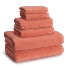 towels stacked on top of each other in an orange color, with one folded up