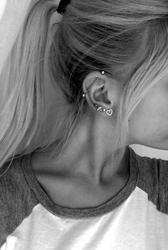 black and white photo of woman with ear piercings