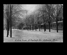 an old black and white photo of trees on a snowy day with the words winter scene & crescent street at jefferson one