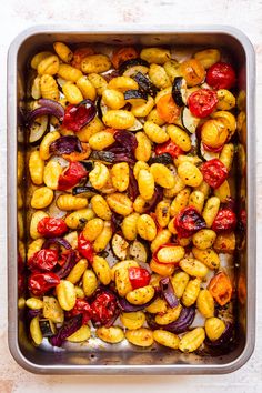 a pan filled with roasted vegetables on top of a table