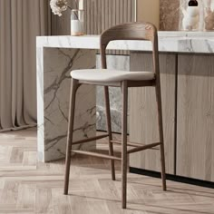 a bar stool sitting in front of a counter with flowers and vases on it