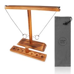 a wooden balance beam with two balls on it and a bag in front of it