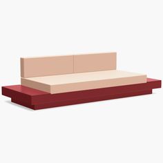 a red and beige couch sitting on top of a white floor