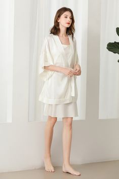 Fabric: 92% 19 Momme mulberry silk 8% Spandex Color: White Care: Hand wash or dry clean Silk robe dressing gown. Dolman sleeves. Shawl collar. Dropped shoulders. Open front. Fastens with a matching belt. Closing edge. Unlined. This wrap is designed with kimono proportions, but with a more modern short length. Elegant V-neck Loungewear Sets, Silk V-neck Kimono For Daywear, Satin V-neck Robe For Loungewear, Elegant V-neck Night Sets, Elegant V-neck Robe For Daywear, Silk Fitted Robe For Loungewear, Elegant Spring Sleepwear With Kimono Sleeves, Elegant Sleepwear With Kimono Sleeves For Spring, Fitted Silk Robe For Loungewear