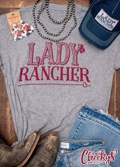 Cheekys Boutique ~ Lady Rancher Unisex Tee On Gravel Road Gray! This is a unisex fit, please see the sizing chart to find the best fit for you. 50% Polyester 25% Cotton 25% Modal All images & designs are copyrighted & we have worked very hard to make them. Please feel free to use our images for social media & sharing, but please give credit when doing so. Thank you for shopping with Cheekys!! Fitted Letter Print Shirt For Fall, Fitted Gray T-shirt With Text Print, Fitted Gray Text Print T-shirt, Fitted Gray T-shirt With Letter Print, Trendy Fitted Pre-shrunk Shirt, Gray Graphic Print Tops For All Genders, Unisex Graphic Tee For Fall, Fitted Letter Print Tops For Fans, Trendy Unisex T-shirt For Fall