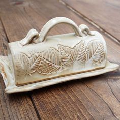 a ceramic purse sitting on top of a wooden table