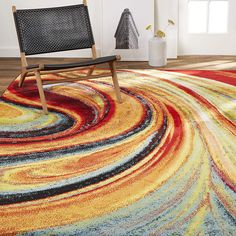 a chair sitting on top of a colorful rug