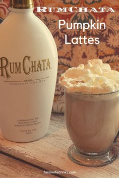 a bottle of rumchata next to a cup of hot chocolate with whipped cream