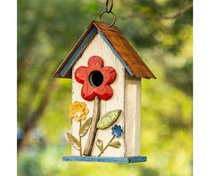 a birdhouse with a flower painted on it