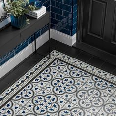 a bathroom with blue and white tiles on the floor