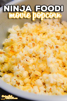 a bowl filled with popcorn sitting on top of a table