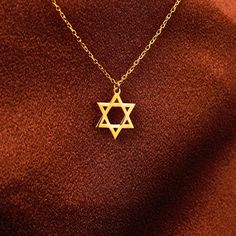 * S T A R * O F * D A V I D * Celebrate your faith with our 14K Solid Gold Dainty Star of David Necklace, a delicate and timeless symbol of Jewish heritage. This tiny David Star necklace is meticulously crafted in solid gold, perfect for those who appreciate minimalistic yet meaningful jewelry. The elegant Star of David pendant is ideal for everyday wear, adding a subtle touch of spirituality to your look. Whether you're searching for a thoughtful Jewish jewelry gift or a beautiful piece for you Jewish Star Necklace, Jewish Necklace, David Star, Star Of David Necklace, Jewish Heritage, Jewish Star, Necklace Star, Timeless Symbol, Jewish Jewelry