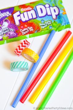 the candy bar is next to four different colored straws