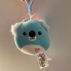 a blue and white stuffed animal with a toothbrush hanging from it's side