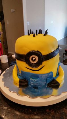 a yellow and black cake sitting on top of a table