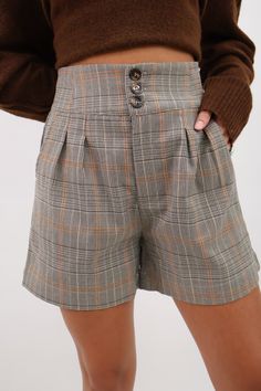 Effortlessly elevate your style with our Fall Plaid Shorts! These classic high waisted pleated shorts feature a tailored design and a triple button front for a polished look. Perfectly paired with a cozy sweater and boots, these shorts will add a touch of sophistication to any outfit. Upgrade your fall wardrobe now! Fall plaid tailored shorts High waisted Pleated front Elastic back Triple buttin front Side pockets Emma is 5'2" wearing a small High waisted plaid shorts Women's plaid shorts Fall Loungewear, Outfit Upgrade, Shorts High Waisted, Fall Plaid, Tailored Shorts, Tailored Design, Pleated Shorts, Short Leggings, Plaid Shorts