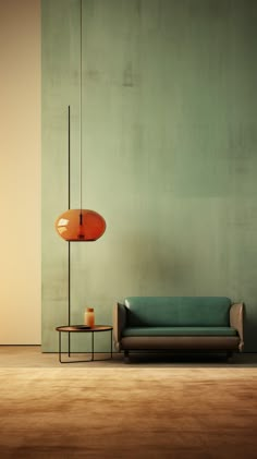 a living room with a couch, table and lamp on the floor in front of a green wall