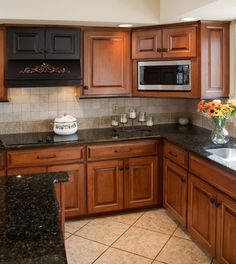 a kitchen with wooden cabinets and granite counter tops