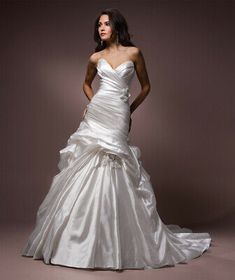 a woman in a white wedding dress posing for the camera