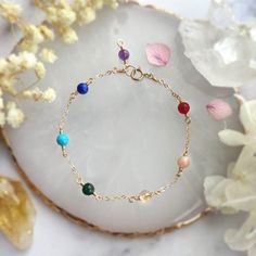 ✨ Seven Chakra Gemstone Bracelet with 14K Gold Filled, Rose Gold Filled, Sterling Silver Delicate Layering Bracelet, Rainbow Stone Bracelet ✨• Handmade in your preferred size with genuine gemstone beads. All metal parts are made with 14K Gold Filled, Rose Gold Filled, or 925 Sterling Silver.• Gemstone size: 4 mm• Seven gemstones representing the 7 energy points in your body or "chakra". It is well believed in the spiritual world that keeping these 7 points well-balanced is the key to a healthy b Gold Gemstone Bracelet In 14k Gold Filled, 14k Gold Filled Gemstone Bracelets, 14k Gold-filled Gemstone Bracelets, Dainty 14k Gold Gemstone Bracelets, 14k Gold-filled Yellow Gold Bracelets With Birthstone, 14k Gold Filled Yellow Gold Bracelets With Birthstone, 14k Yellow Gold Filled Birthstone Bracelets, Dainty Yellow Gold Bracelet With Natural Stones, Adjustable Yellow Gold Multi-stone Bracelets