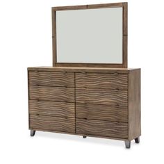 a dresser with a mirror on top of it and wooden drawers underneath the drawers