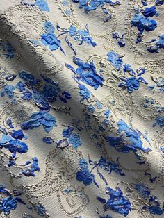 blue and white fabric with floral designs on it