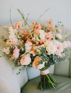 a bouquet of flowers sitting on top of a couch