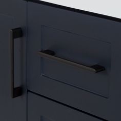 a close up of a black cabinet door with handles and knobs on the front