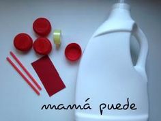 a white jug with red buttons and some other items next to it on a table