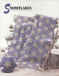 an old crocheted blanket with snowflakes on it