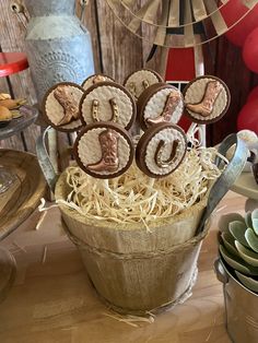 an arrangement of cookies in a bucket with the number six on them and other decorations