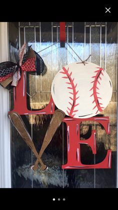 a baseball themed door hanger with the letter e and two baseballs on it