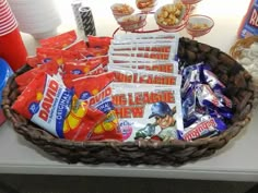 a basket filled with candy and snacks on top of a table