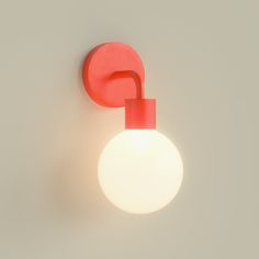 a light that is on the wall next to a white ball with a red handle